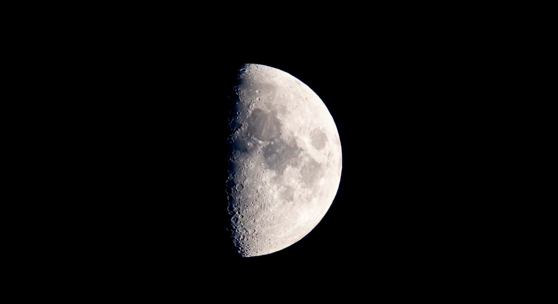 Half moon photographed against a black night sky