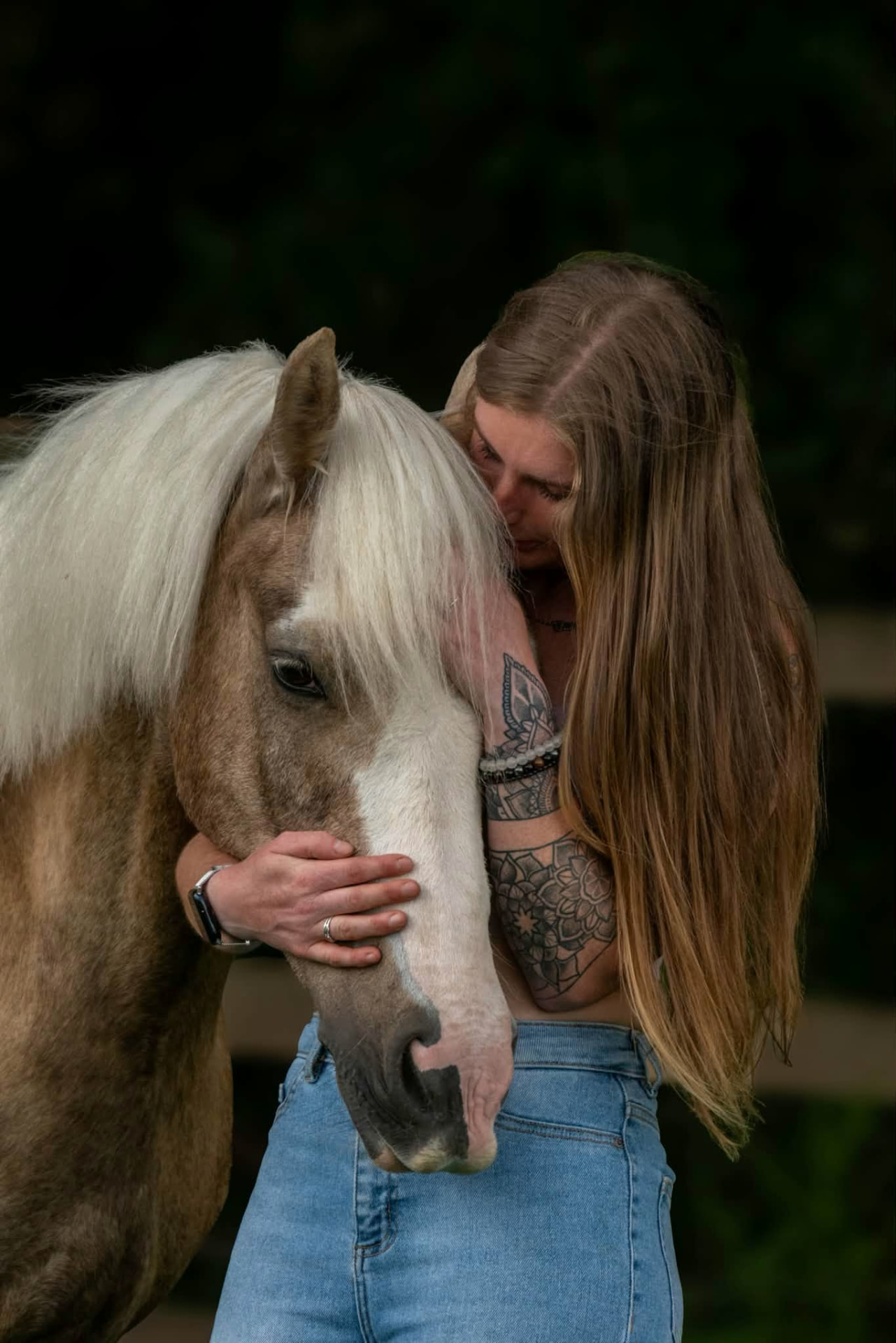 Woman embracing her horse in a quiet, intimate moment